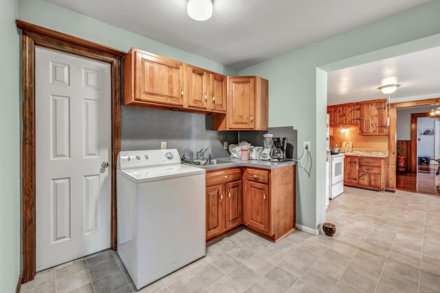 laundry room with laundry area, washer / dryer, and a sink