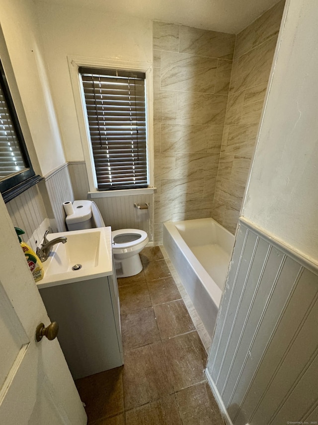 full bath featuring vanity, toilet, and wainscoting