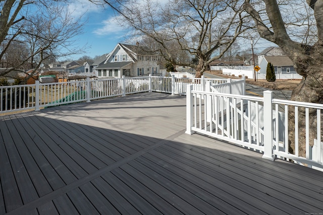 wooden deck featuring fence and a residential view