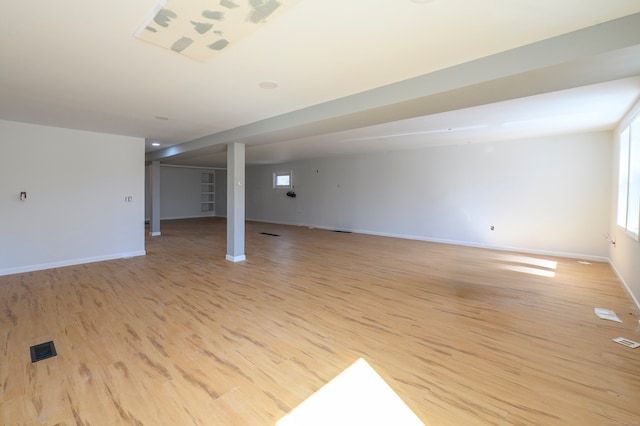 interior space with plenty of natural light, light wood-style flooring, and baseboards