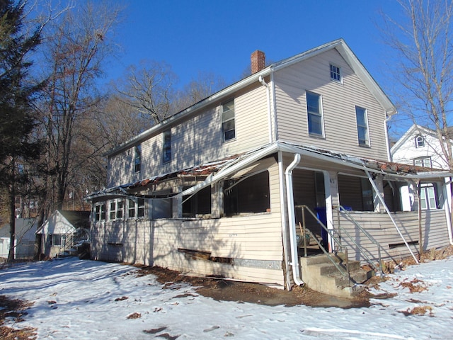 view of front facade featuring a chimney