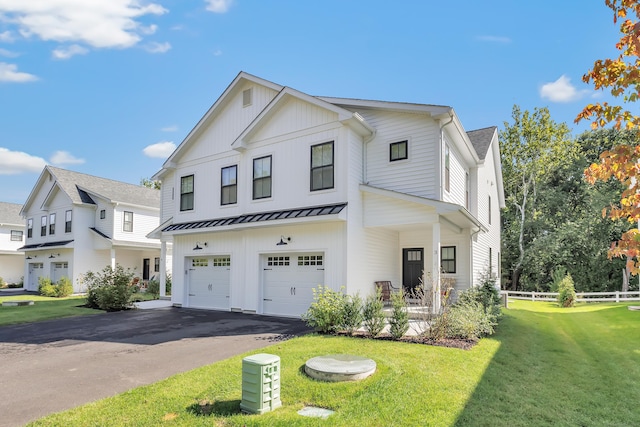 modern inspired farmhouse featuring driveway, fence, board and batten siding, a front yard, and a garage