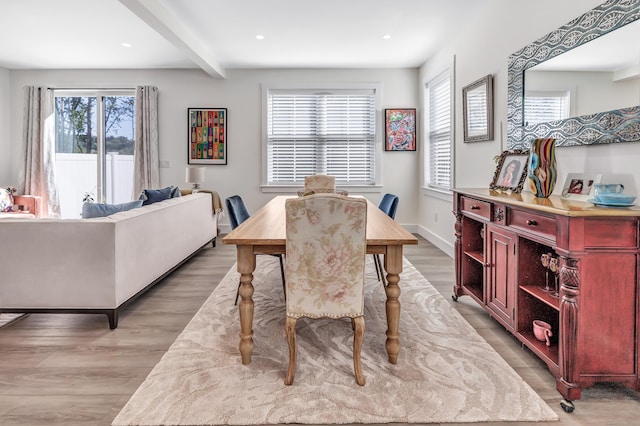 dining room with beam ceiling, recessed lighting, light wood-type flooring, and baseboards