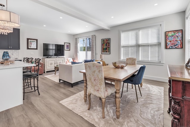 dining space with beam ceiling, recessed lighting, light wood-style flooring, and a notable chandelier