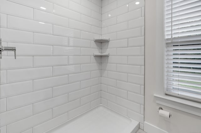 full bath with a tile shower