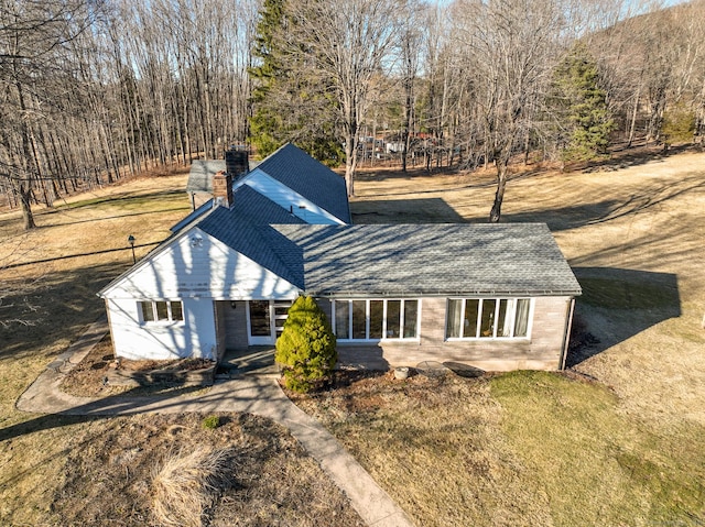 view of front of house with a front lawn and a chimney