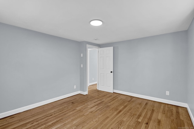 unfurnished room with wood finished floors and baseboards