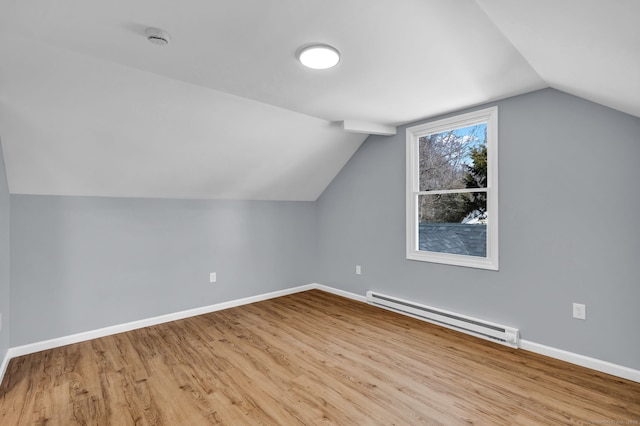 bonus room featuring vaulted ceiling, baseboard heating, baseboards, and wood finished floors