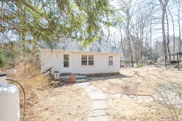 exterior space with a shingled roof