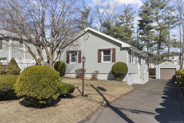 view of front of home with an outbuilding, a garage, and driveway