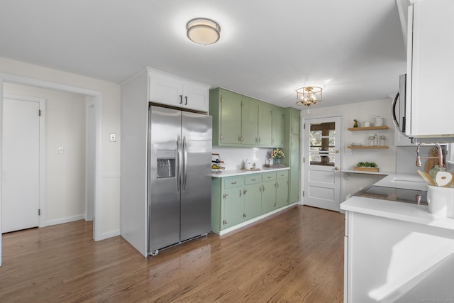 kitchen with green cabinets, light countertops, dark wood-type flooring, and appliances with stainless steel finishes