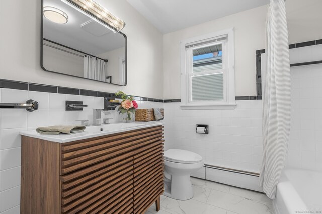 full bath with toilet, marble finish floor, a baseboard heating unit, tile walls, and vanity