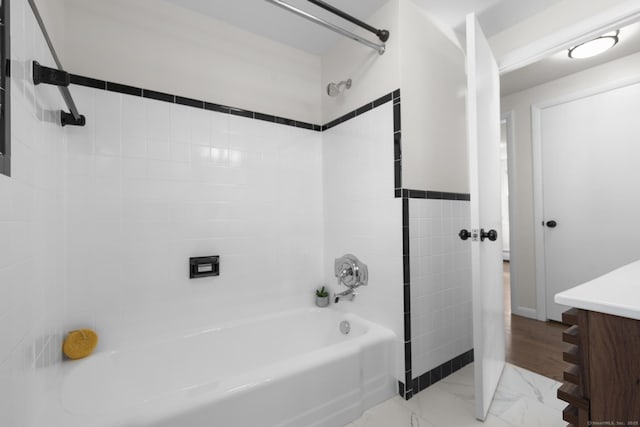 bathroom featuring shower / bath combination, marble finish floor, and vanity