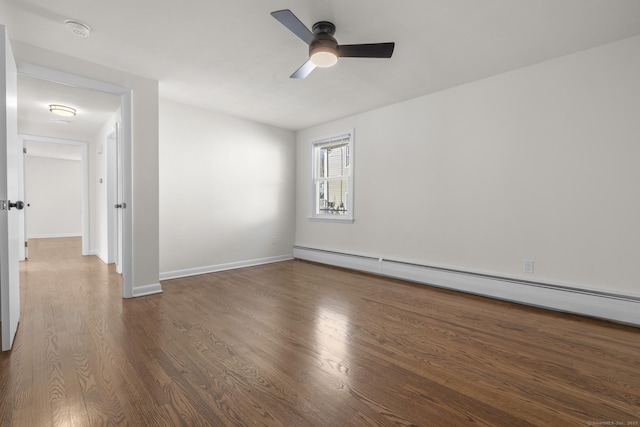 empty room featuring a baseboard radiator, baseboards, wood finished floors, and a ceiling fan