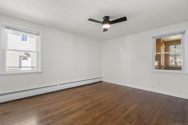 spare room with baseboards, dark wood-type flooring, baseboard heating, and ceiling fan