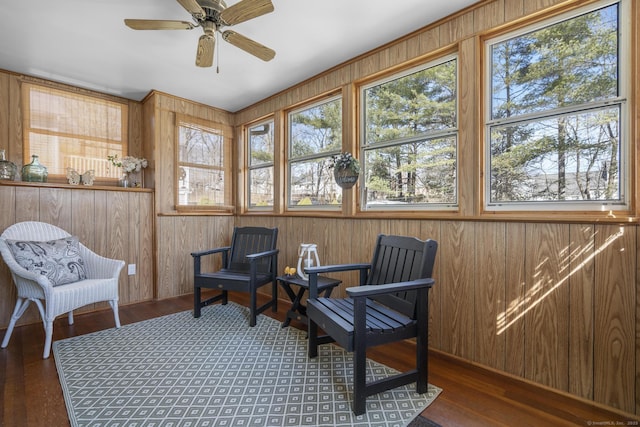 sunroom / solarium featuring a ceiling fan