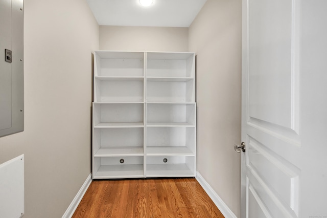 interior space featuring electric panel and wood finished floors