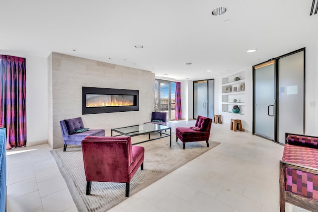 living area with visible vents, a large fireplace, baseboards, built in features, and recessed lighting