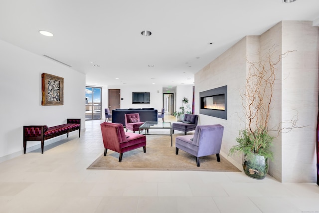 living room featuring recessed lighting, visible vents, and a large fireplace