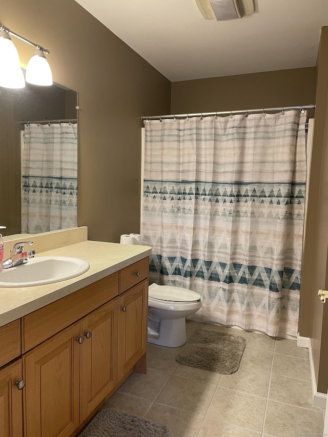 full bath with tile patterned floors, curtained shower, toilet, and vanity