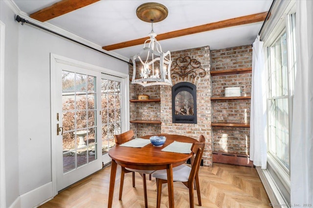 dining space featuring beamed ceiling, plenty of natural light, and an inviting chandelier