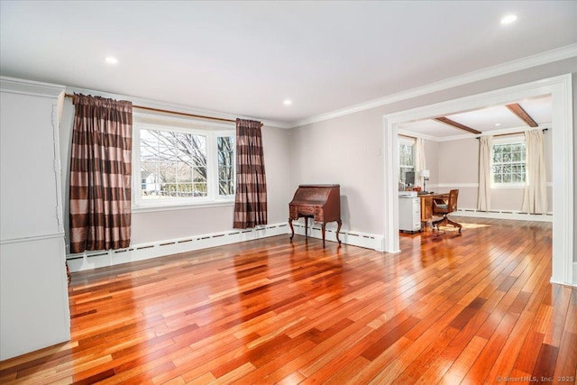 empty room with recessed lighting, a baseboard radiator, wood-type flooring, and crown molding