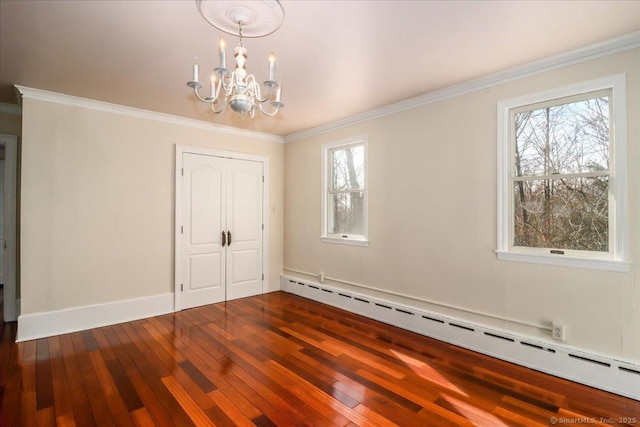 interior space with wood-type flooring, baseboard heating, a chandelier, and crown molding