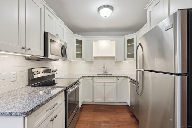 1042 Heritage Vlg Unit A, Southbury, CT 06488 - kitchen featuring stainless steel appliances, a sink, backsplash, glass insert cabinets, and light stone counters