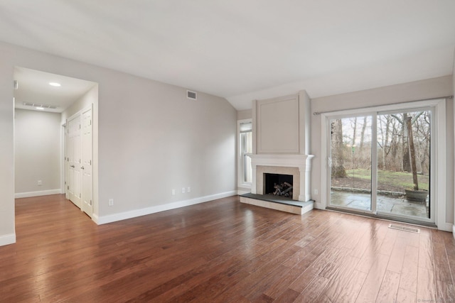 1042 Heritage Vlg Unit A, Southbury, CT 06488 - unfurnished living room featuring wood finished floors, baseboards, and a fireplace with raised hearth