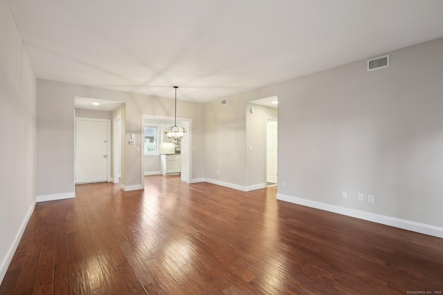 1042 Heritage Vlg Unit A, Southbury, CT 06488 - unfurnished living room with a chandelier, hardwood / wood-style flooring, and baseboards