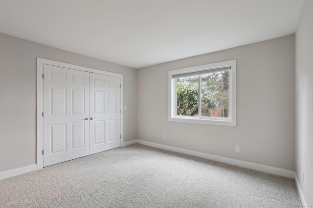 1042 Heritage Vlg Unit A, Southbury, CT 06488 - unfurnished bedroom featuring carpet flooring, baseboards, and a closet