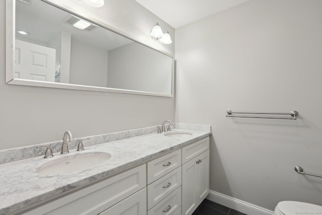 1042 Heritage Vlg Unit A, Southbury, CT 06488 - full bathroom with double vanity, tile patterned floors, baseboards, and toilet