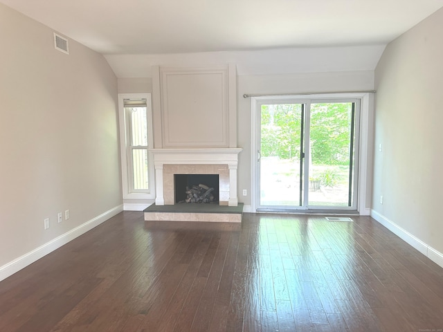 1042 Heritage Vlg Unit A, Southbury, CT 06488 - unfurnished living room featuring lofted ceiling, dark wood finished floors, baseboards, and a high end fireplace