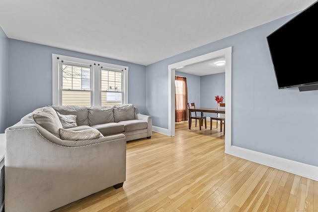 living room featuring light wood-style flooring and baseboards