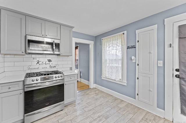 kitchen with light countertops, appliances with stainless steel finishes, and gray cabinetry