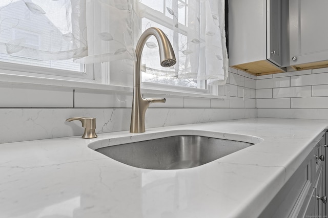 details with a sink and decorative backsplash