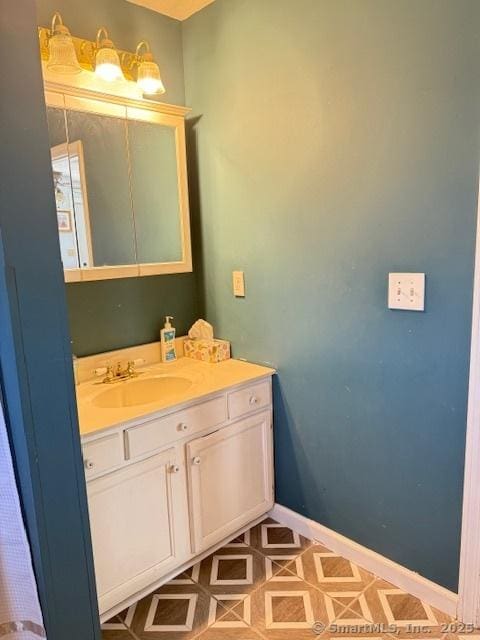 bathroom featuring baseboards and vanity