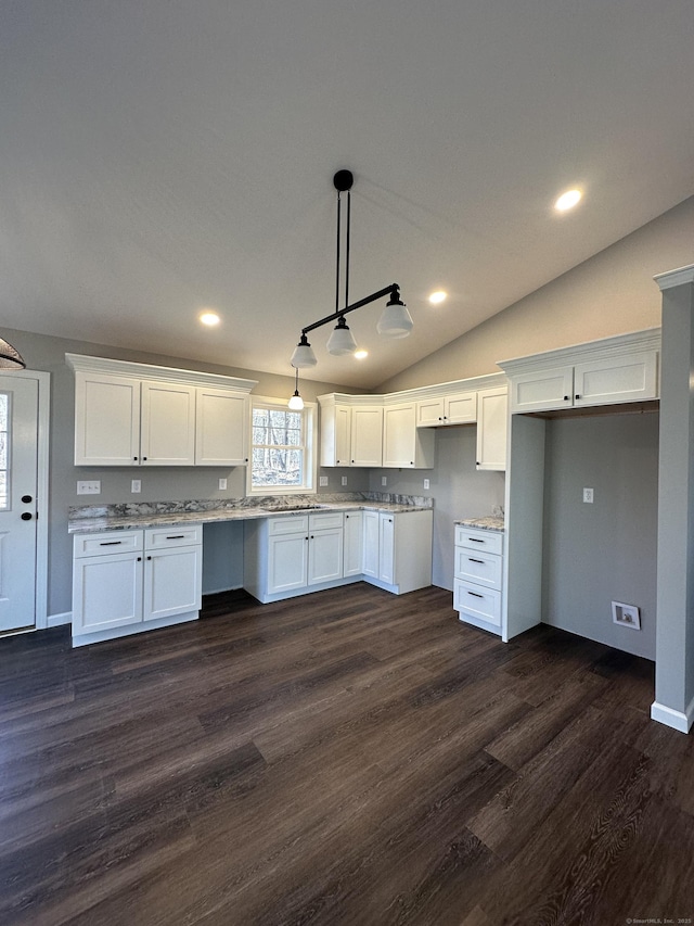 kitchen with white cabinetry, vaulted ceiling, and dark wood-type flooring