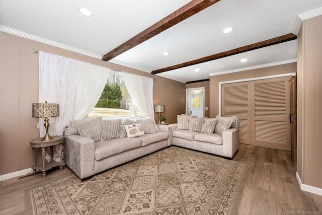 living room featuring beam ceiling, recessed lighting, wood finished floors, and ornamental molding