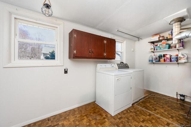 laundry room with cabinet space, washer and dryer, and baseboards