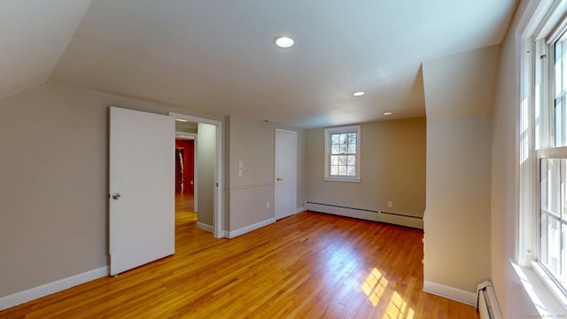 interior space with light wood-style flooring, baseboards, and a baseboard radiator