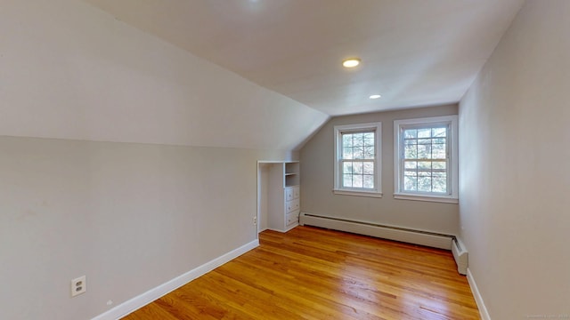 bonus room with recessed lighting, light wood finished floors, a baseboard radiator, baseboards, and vaulted ceiling