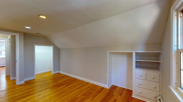 bonus room with baseboards, visible vents, lofted ceiling, light wood-style flooring, and recessed lighting