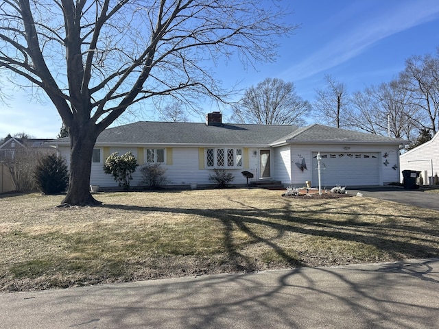 single story home featuring a garage, driveway, a chimney, and a front yard