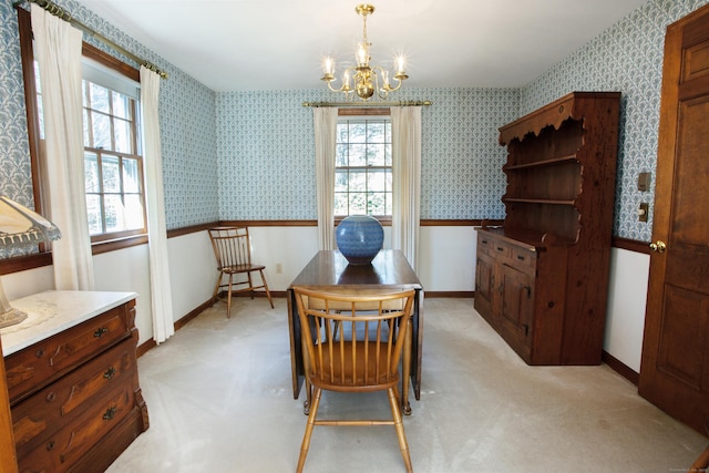 dining area with a notable chandelier, light colored carpet, wallpapered walls, and baseboards