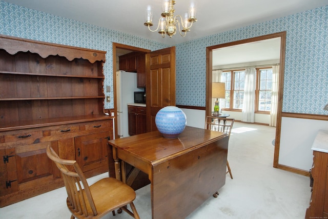 office space featuring baseboards, an inviting chandelier, and wallpapered walls