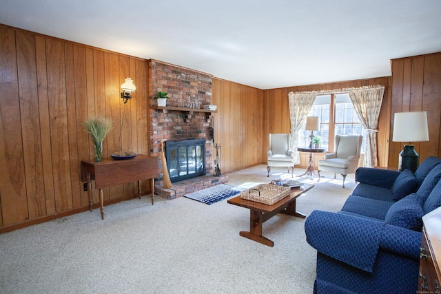 living room with wooden walls, a fireplace, baseboards, and carpet floors