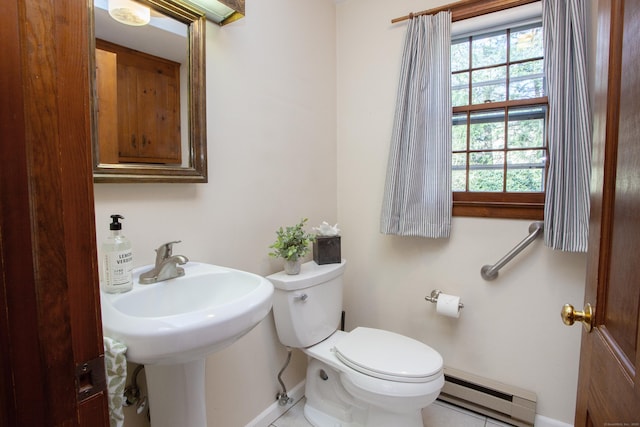 bathroom featuring toilet and a baseboard radiator