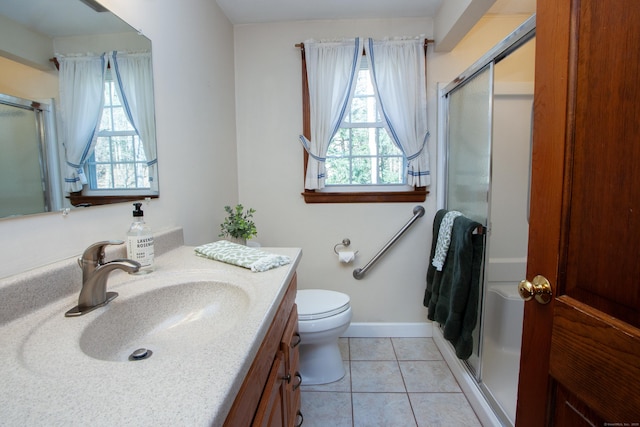 bathroom featuring toilet, a stall shower, tile patterned flooring, baseboards, and vanity