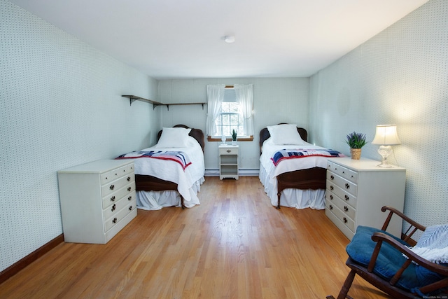 bedroom with light wood-type flooring and wallpapered walls